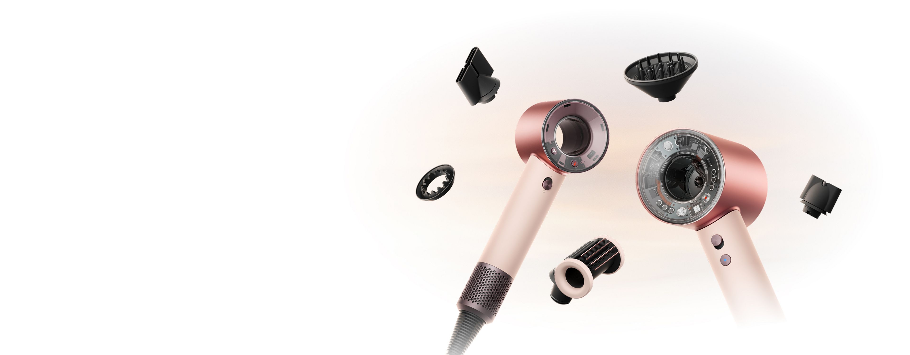 Фены Dyson Supersonic Nural и Travel в окружении насадок.